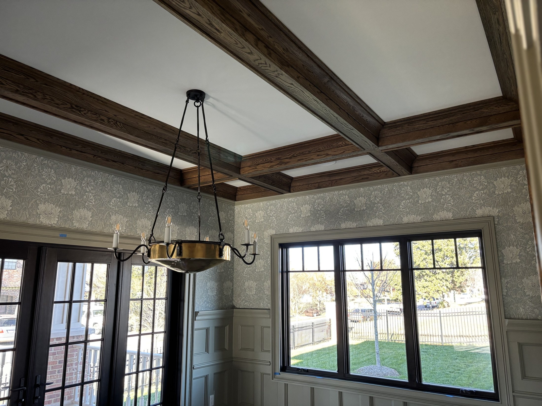 Dining room with exposed oak ceiling beams and brass chandelier