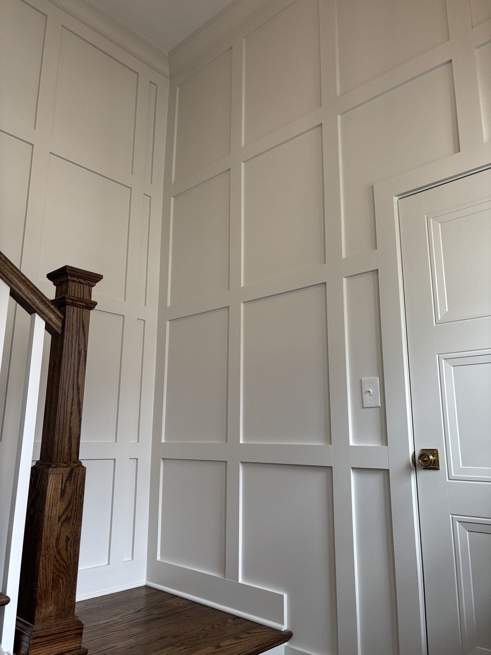 Picture-frame wainscoting on a tall stair wall