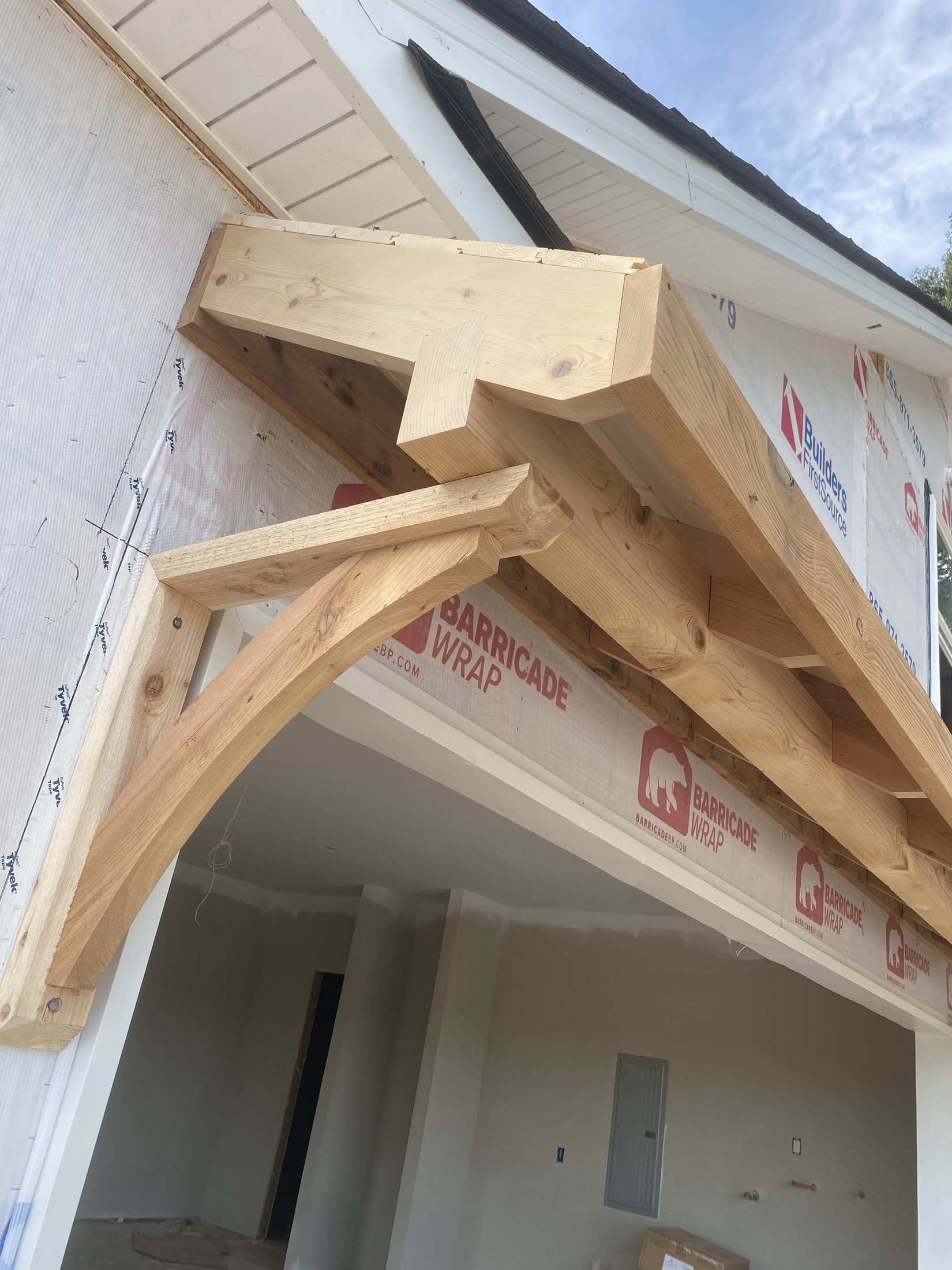 Cedar timber bracket and rafter framing on a covered porch
